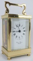 An English David Peterson brass eleven jewels carriage clock. Key included. 13 cm height.