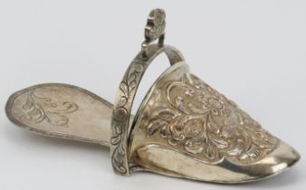 A Peruvian plated copper ladies stirrup, 19th century. Of slipper form, repoussé decorated with