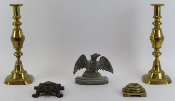 A pair of late Victorian brass candlesticks, two Victorian fire iron rests and a cast lead eagle