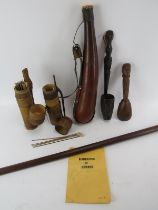 A group of tribal items including a Borneo blow pipe with sheaths, darts and book entitled ‘Pipes of