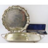 A large silver plated Georgian style salver (45cm diameter), a long two handled serving tray and a