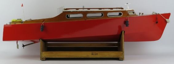 Toys and Models: An RC pleasure cruiser model boat. With a painted red hull and varnished decking.