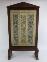 A Chinese silk Peking knot embroidery panelled Arts & Crafts mahogany fire screen, 19th century.