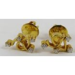 A pair of yellow precious metal and diamond earstuds of abstract design, set with approximately 0.