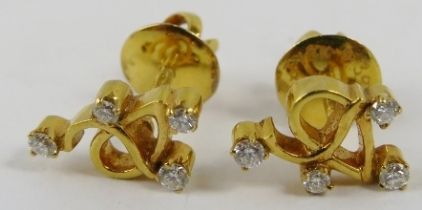 A pair of yellow precious metal and diamond earstuds of abstract design, set with approximately 0.