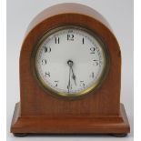 A French walnut mantel clock, early 20th century. With satinwood stringing, white enamelled dial and