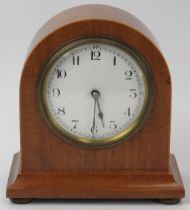 A French walnut mantel clock, early 20th century. With satinwood stringing, white enamelled dial and