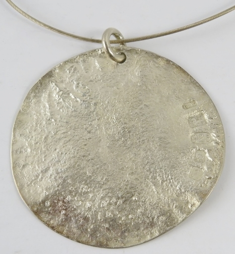 A large silver Artisanal disc pendant, 7.8cm diameter approx, on silver wire collar, with feature - Image 2 of 2