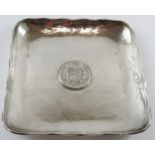 A square planished silver dish with inset Peruvian 1882 9 Decimos coin. 15.5cm x 15.5cm. Marked