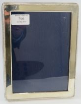 A silver mounted rectangular photo frame with beaded border and blue velvet easel back. 21.5cm x