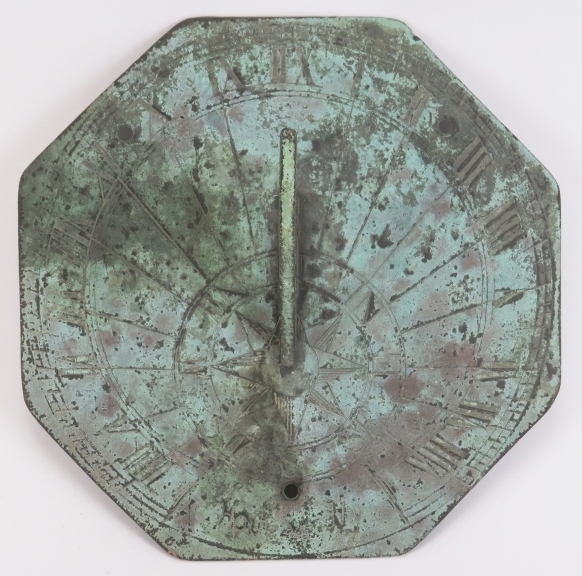 An octagonal bronze sundial, probably 18th/19th century. The octagonal plate with angular S scrolled