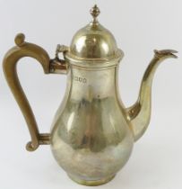A silver baluster form coffee pot with fruitwood handle. Hallmarked for London 1912, maker