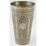 A Far Eastern hand decorated white metal beaker with floral and bamboo panels. Height 14.5cm.