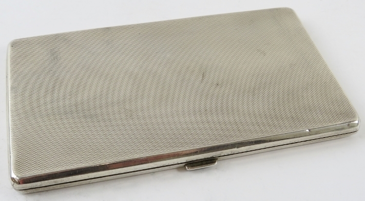 A machine turned silver cigarette case with gilded interior. Hallmarked for Birmingham 1933, maker