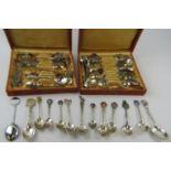 A collection of mainly silver souvenir spoons from countries all over the world, many enamelled.
