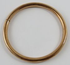 A 9ct rose gold hollow circular bangle tension sprung, 8.5cm external diameter
