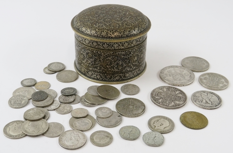 A quantity of mainly British, Dutch and US silver coins within a Damascene enamel decorated