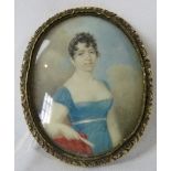 A 19th century miniature on mother of pearl, 'Study of a young lady in blue dress', unsigned. 6cm