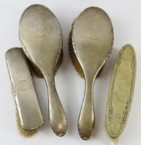 Four antique silver backed brushes, three with a monogram B. All fully hallmarked.