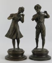 A pair of Italian bronze figures depicting a girl with violin and boy with flute, signed Lancini,