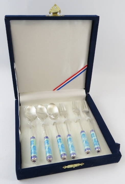 A cased set of South Korean silver and enamel spoons and forks, marked 999%.