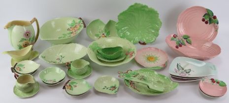 A large group of Carlton Ware porcelain wares. A variety of patterns decorated against green, pink