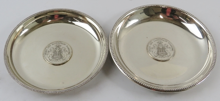Two German silver dishes with inset three Mark coins and beaded rims. Largest 12.5cm diameter.