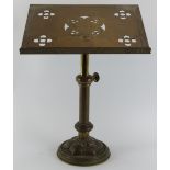 An ecclesiastical brass pedestal lectern, late 19th/early 20th century. The slope decorated with