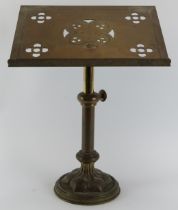 An ecclesiastical brass pedestal lectern, late 19th/early 20th century. The slope decorated with