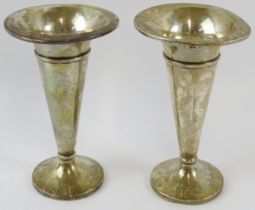 A pair of silver trumpet form bud vases, hallmarked for Birmingham 1921, maker A & J Zimmerman