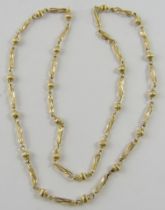 A 9ct yellow gold fancy link neckchain with alternating ribbed bead and open twisted links,