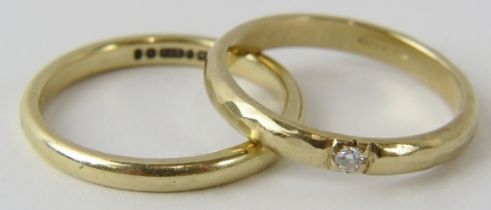 A plain 9ct gold wedding band (size P) and a planished 9ct gold solitaire diamond ring (size O).