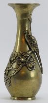 A Japanese brass vase, late Meiji/Taisho period. Decorated in relief with a bird perching on a