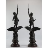 A large pair of bronzed spelter figures, 20th century. Modelled depicting a male and female