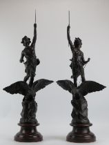A large pair of bronzed spelter figures, 20th century. Modelled depicting a male and female