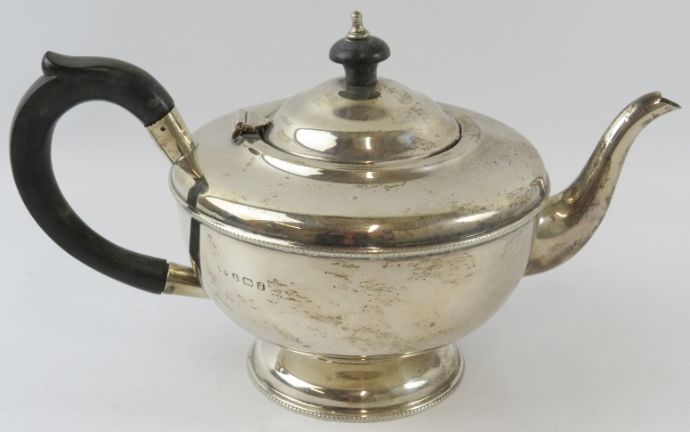 A 1930s silver teapot with ebony handle and finial. Hallmarked for Birmingham 1933, maker's mark