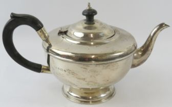 A 1930s silver teapot with ebony handle and finial. Hallmarked for Birmingham 1933, maker's mark