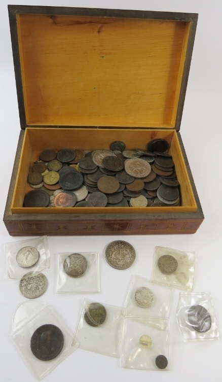 A carved wood box of mixed 19th and 20th century British, European and world coins including a Queen