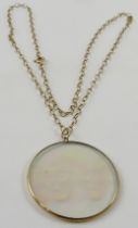 A 9ct yellow gold trace link chain with a novelty pendant inset a hologram depicting the Greek