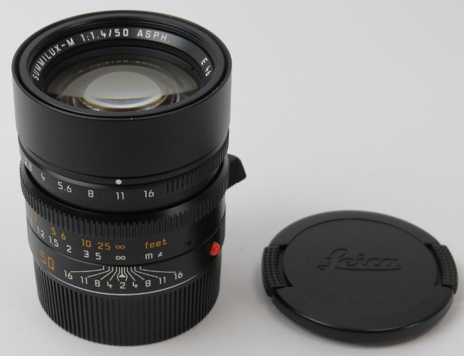 A Leica Summilux-M 1:1.4 50mm ASPH E46 black camera lens. Caps, case and box included. Serial