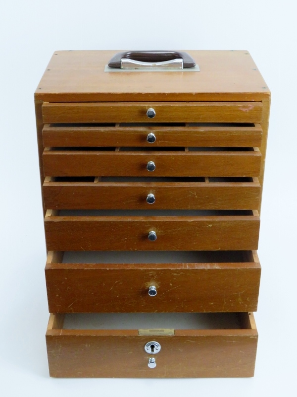 A vintage dentist’s walnut cabinet. With seven graduated draws, the top four compartmented. 41 cm