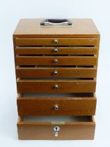 A vintage dentist’s walnut cabinet. With seven graduated draws, the top four compartmented. 41 cm