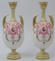 A pair of Royal Worcester twin handled gilt porcelain vases, circa 1900. Both of ovoid form, hand