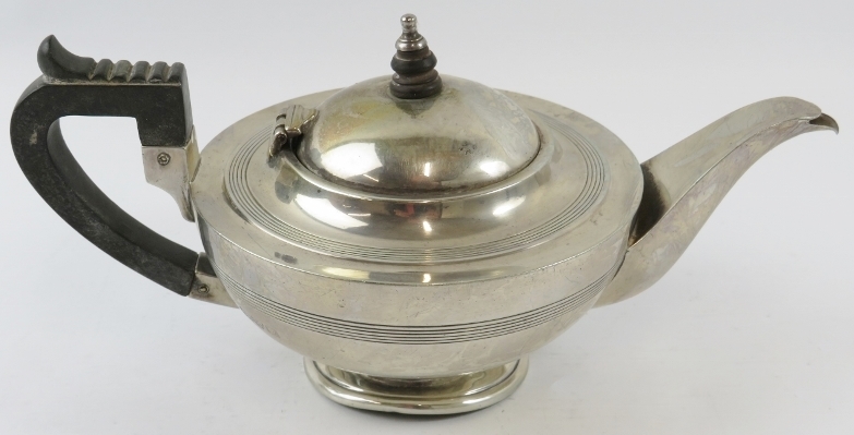 A silver Art Deco teapot with ebony handle and finial. Hallmarked for Chester 1919, maker Barker