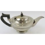 A silver Art Deco teapot with ebony handle and finial. Hallmarked for Chester 1919, maker Barker