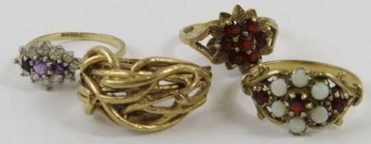 Four 9ct yellow gold rings, variously set with opals, garnets, amethyst and one wirework, gross