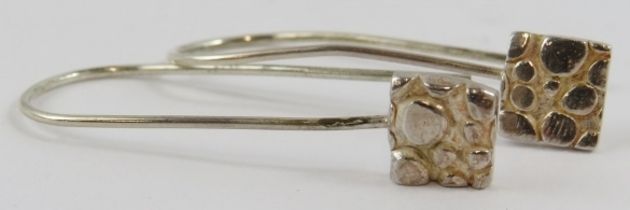 A pair of Artisanal silver earrings with square pendants below long shepherds crook fittings, 4cm