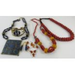 A collection of Middle Eastern Berber style beaded necklaces and other resin jewellery in the manner