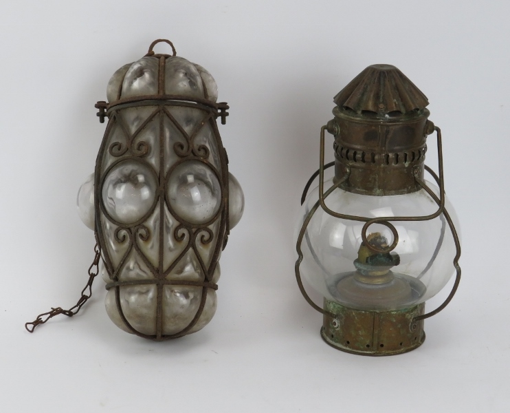 A Venetian wrought iron and glass lantern and a hanging brass oil lamp by Sherwood of Birmingham,