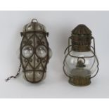 A Venetian wrought iron and glass lantern and a hanging brass oil lamp by Sherwood of Birmingham,
